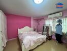 Bedroom with pink walls and white furniture