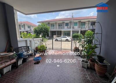 Covered outdoor area with plants and street view