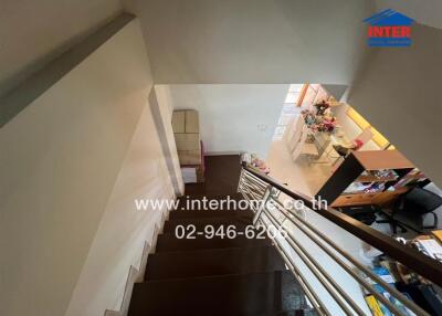 Staircase view of a property with visible parts of upper and lower floors