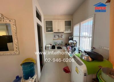 Small kitchen with appliances and wall-mounted cabinets