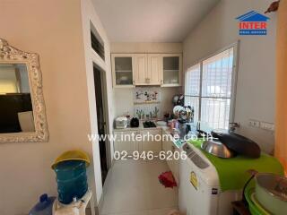 Small kitchen with appliances and wall-mounted cabinets