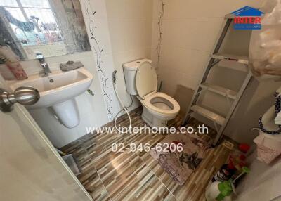 Bathroom with sink, toilet, and storage ladder