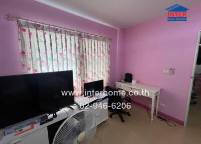 Bedroom with pink walls and a desk
