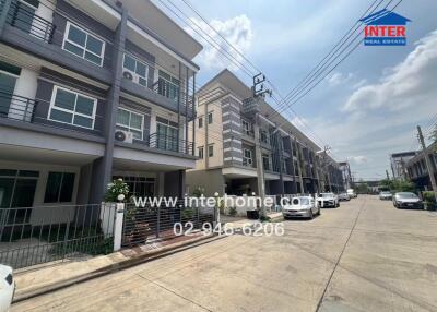 Front view of a modern apartment complex with three-story buildings