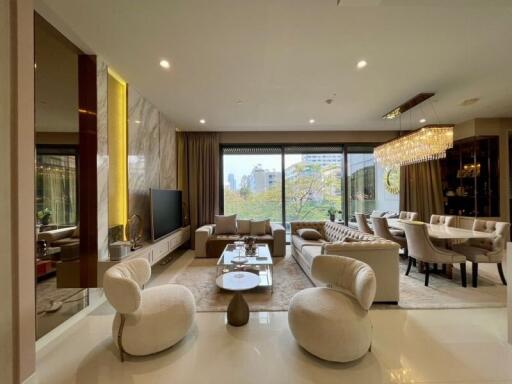 Modern living and dining area with large windows and elegant furnishing