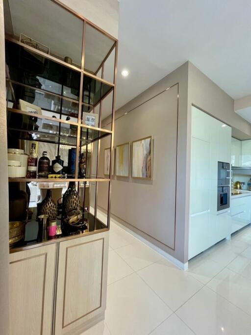 Modern kitchen with white cabinetry and decorative shelving