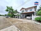 Two-story house with front driveway and carport