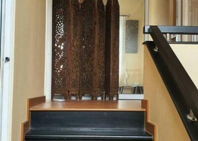 Indoor staircase with wooden floors and decorative screen