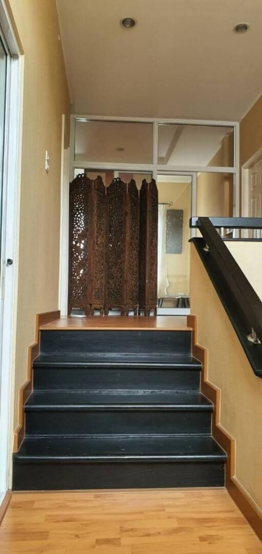 Indoor staircase with wooden floors and decorative screen