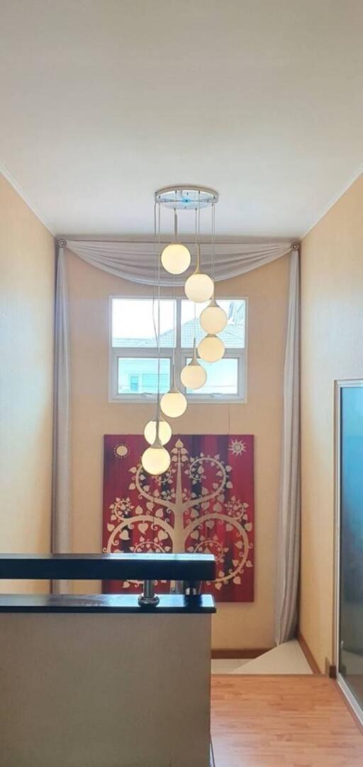 Hallway with modern chandelier and artwork