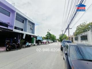 Street view with adjacent buildings and cars parked