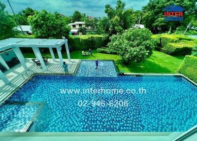 Swimming pool area with greenery and seating