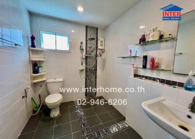 Modern bathroom with shower, toilet, and sink