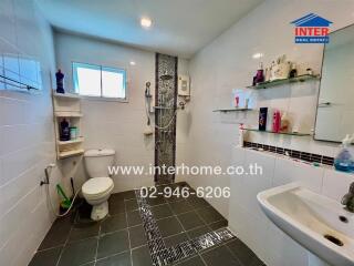 Modern bathroom with shower, toilet, and sink