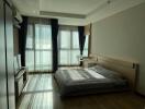 Modern bedroom with large windows and natural light