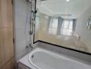 Modern bathroom with a bathtub and a view through a window