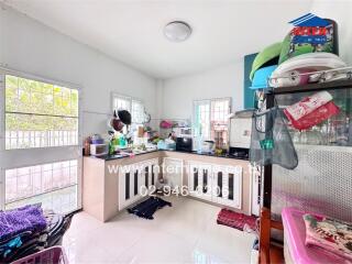 Modern kitchen with appliances, shelves, and window