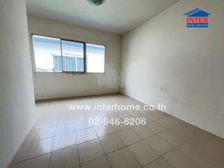 Empty bedroom with tiled floor and window