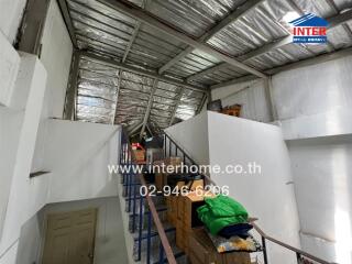 Interior of a storage or attic area with boxes and miscellaneous items