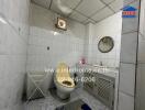 Bathroom with white tiles, sink, mirror, and a toilet