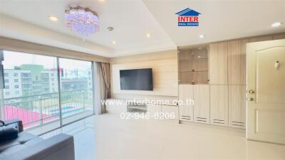 Bright and modern living room with large windows and TV on the wall