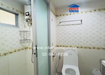 Bathroom with shower, toilet, and utility area