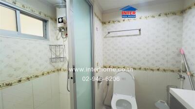 Bathroom with shower, toilet, and utility area