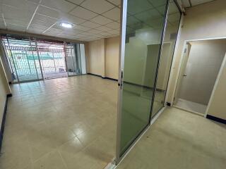 spacious room with tiled floor and glass doors