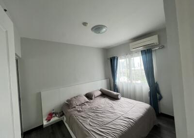 Bedroom with bed, curtains, and air conditioner