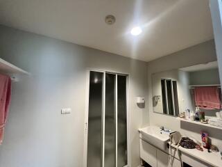 A bathroom with vanity, mirror, and sliding door