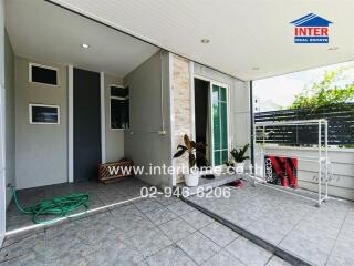 Outdoor terrace area with garden hose and drying rack