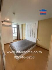 Modern bedroom interior with wooden flooring and air conditioning