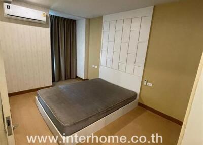 Bedroom with a bed and air conditioning unit