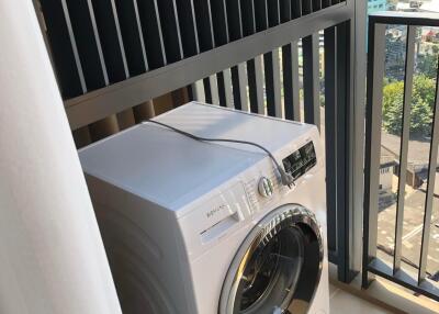 Laundry area with washing machine and city view