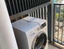 Laundry area with washing machine and city view