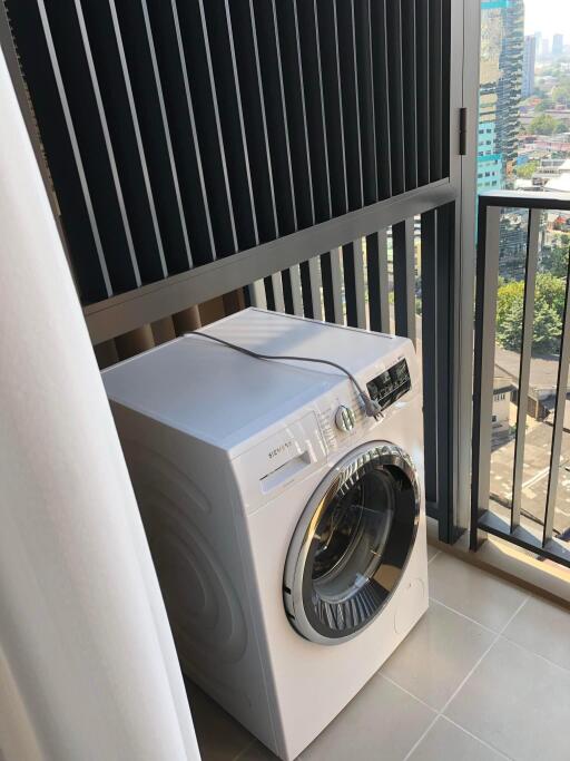 Laundry area with washing machine and city view