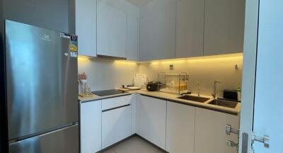 Modern kitchen with stainless steel appliances and under-cabinet lighting