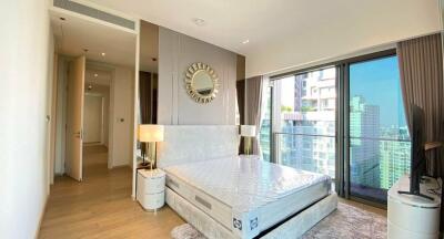 Modern bedroom with large window view of the city