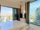 Modern bedroom with large windows and city view