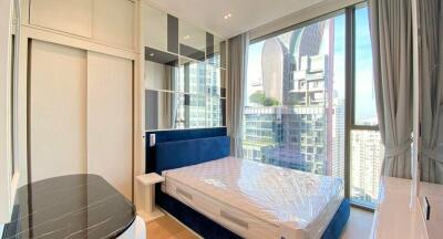 Modern bedroom with large window and city view