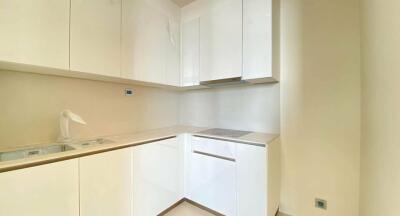 Modern, compact kitchen with white gloss cabinets