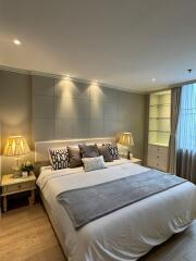 Modern bedroom with double bed, stylish lamps, and cozy decor