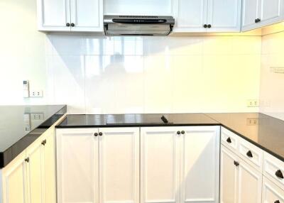 Modern kitchen with white cabinets and black countertops