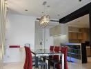 Modern dining area with chandelier and adjacent kitchen