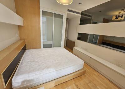 Modern bedroom with built-in storage and large mirrors