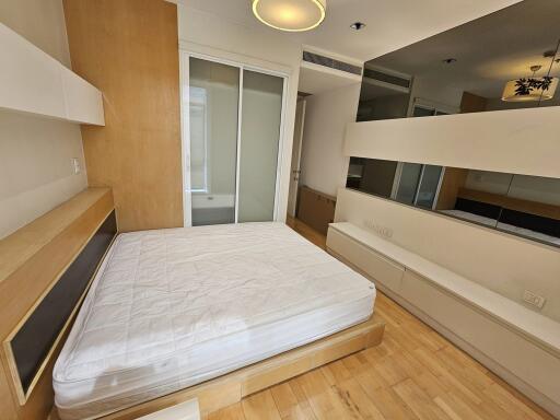 Modern bedroom with built-in storage and large mirrors