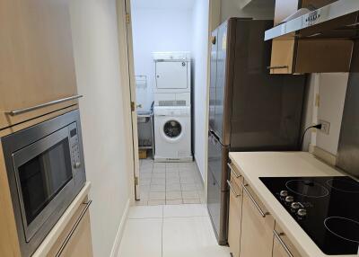 Modern narrow kitchen with appliances and laundry area