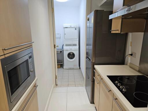 Modern narrow kitchen with appliances and laundry area