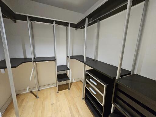 Spacious walk-in closet with shelves and drawers