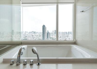 Modern bathroom with large windows and city view